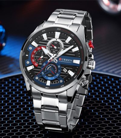 A close-up view of the CURREN 8415 Chronograph watch, showing its silver stainless steel band and black, blue, and red dial.