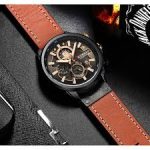 A CURREN 8380 chronograph men's watch with a brown leather strap and rose gold details, displayed on a dark textured surface.