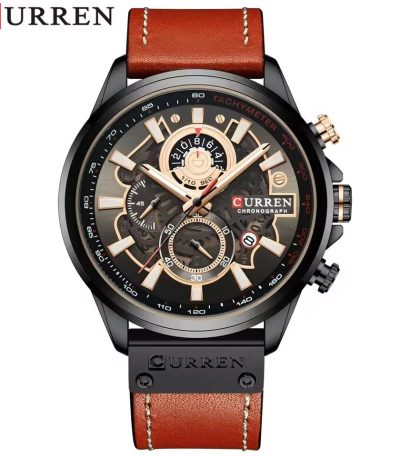 A CURREN 8380 chronograph men's watch with a brown leather strap and rose gold details, displayed on a dark textured surface.