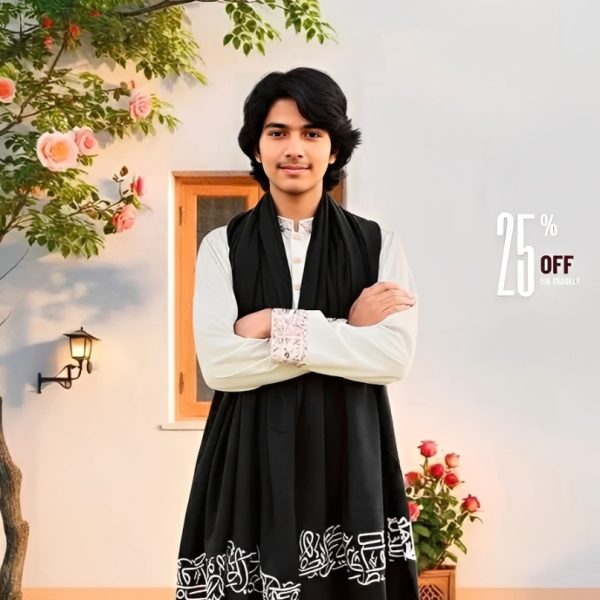 A young man models a black shawl decorated with white Arabic calligraphy and a tasseled fringe.