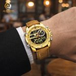 A man wearing a suit and the NAVIFORCE NF9208 Dual Time Watch with a golden case and a brown PU leather strap.