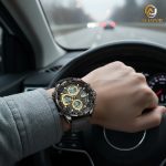 A person wearing the black and gold POEDAGAR E108 analog-digital watch while driving a car on a highway.