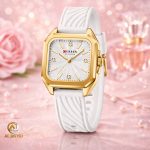 Curren 9113 women's square silicone watch featuring a gold case and a white textured strap, set against a delicate pink background.