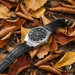 The SKMEI 9390 men's watch with a black Roman numeral dial and a black leather strap, pictured laying on top of fallen leaves.