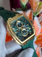 A close-up of the CURREN 8488 men's chronograph watch, showing its green dial, gold-tone square case, and green silicone strap.