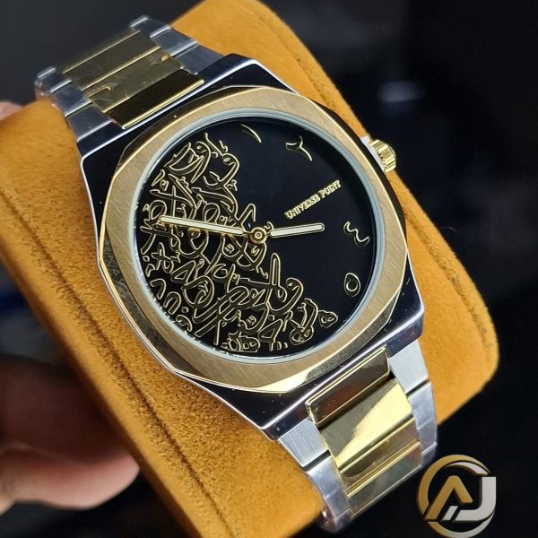 A Universe Point Arabic Calligraphy Watch with a two-tone gold and silver band, held on a yellow cushion to show the black dial.