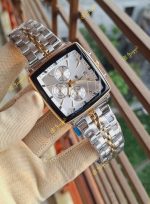 A gloved hand holding the POEDAGAR 866 luxury square wristwatch with its two-tone silver and gold metal bracelet.