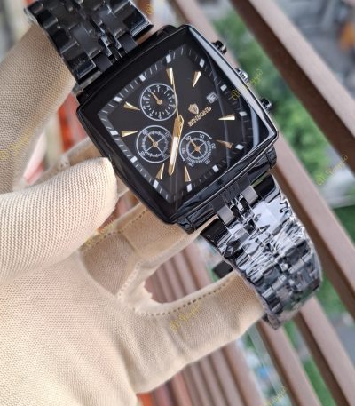 A hand in a beige glove holds up a Binbond 911 Original Men’s Luxury Watch with a square black case and gold accents.