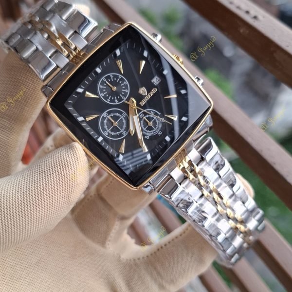 A gloved hand holding a Binbond 911 Original Men’s Luxury Watch, showing its square black face and two-tone silver and gold bracelet.