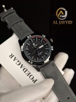 A gloved hand holding the POEDAGAR 895 Luminous Leather Men's Watch with its grey strap and black textured dial.