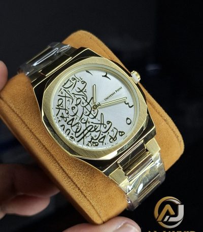 A close-up of the Universe Point Arabic Calligraphy Watch, showing its gold case and silver dial with black calligraphy.