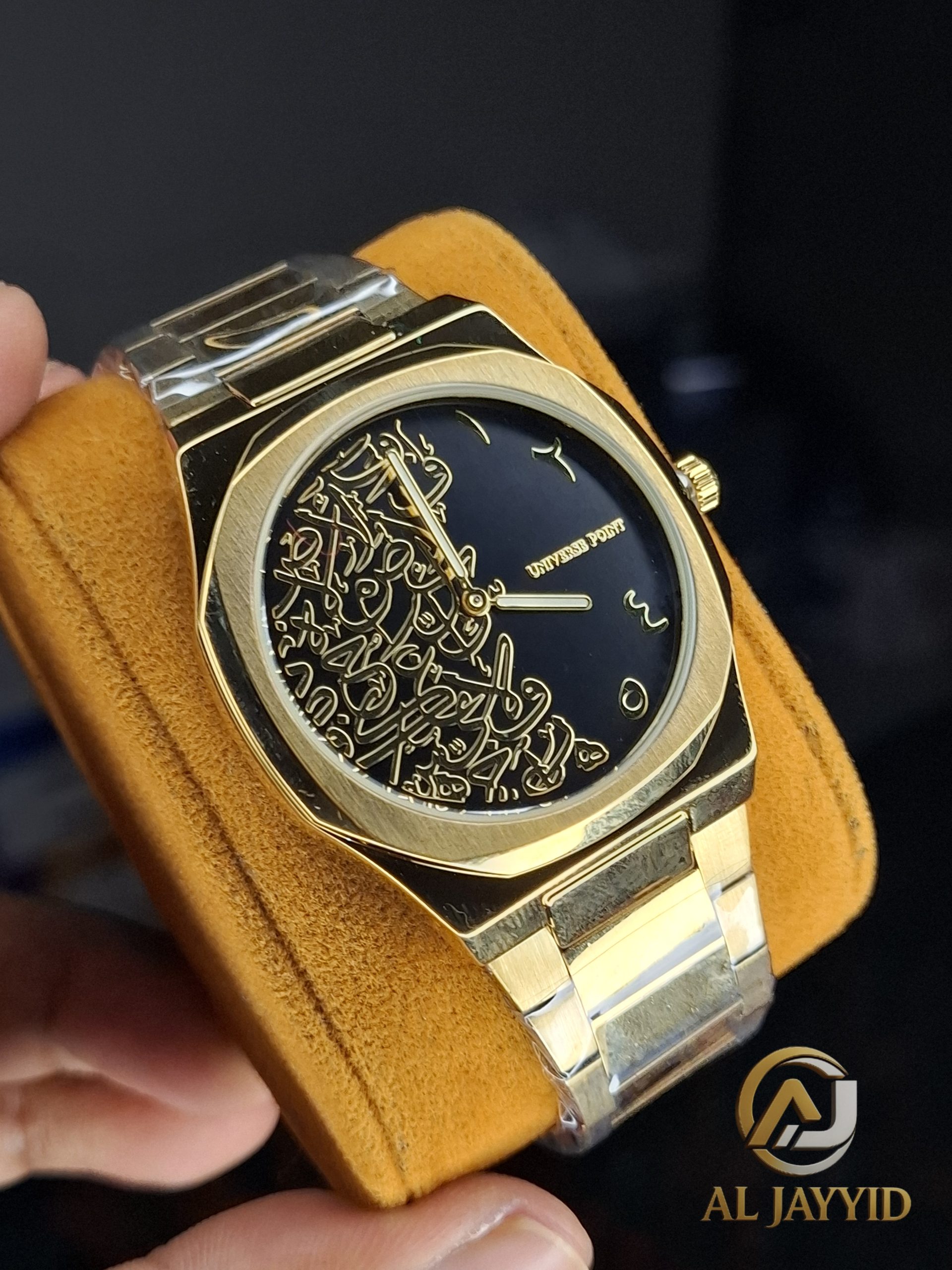 Universe Point Arabic Calligraphy Watch A close-up view of the Universe Point Arabic Calligraphy Watch, showing its gold-toned case and black dial with gold calligraphy.