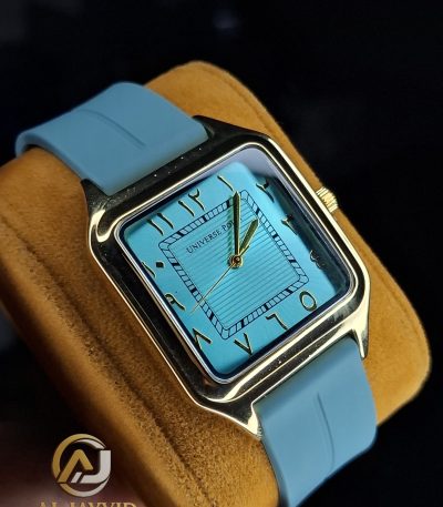 A Universe Point Watch with a gold square case, a tiffany blue dial with Eastern Arabic numerals, and a matching silicone strap.