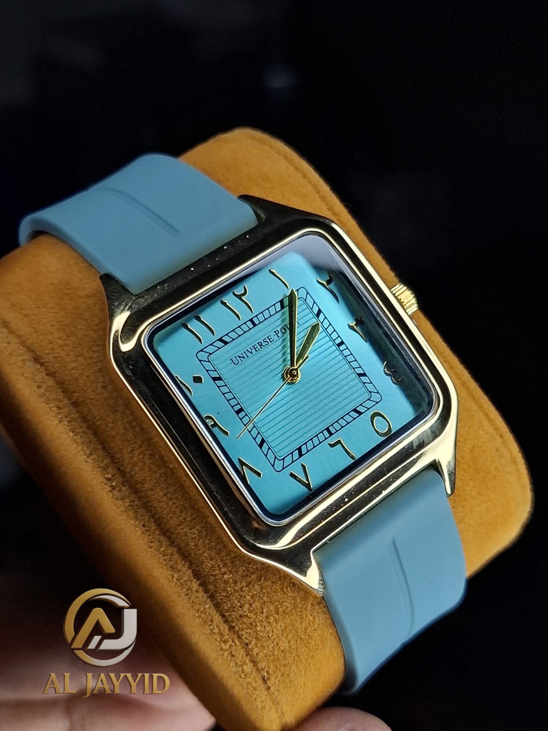 Universe Point Watch with Silicone Strap in Gold / Tiffany A Universe Point Watch with a gold square case, a tiffany blue dial with Eastern Arabic numerals, and a matching silicone strap.