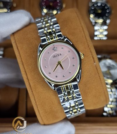 A gloved hand holding an OLIYA 6658 women's watch featuring a two-tone bracelet and a pink dial with crystal markers.