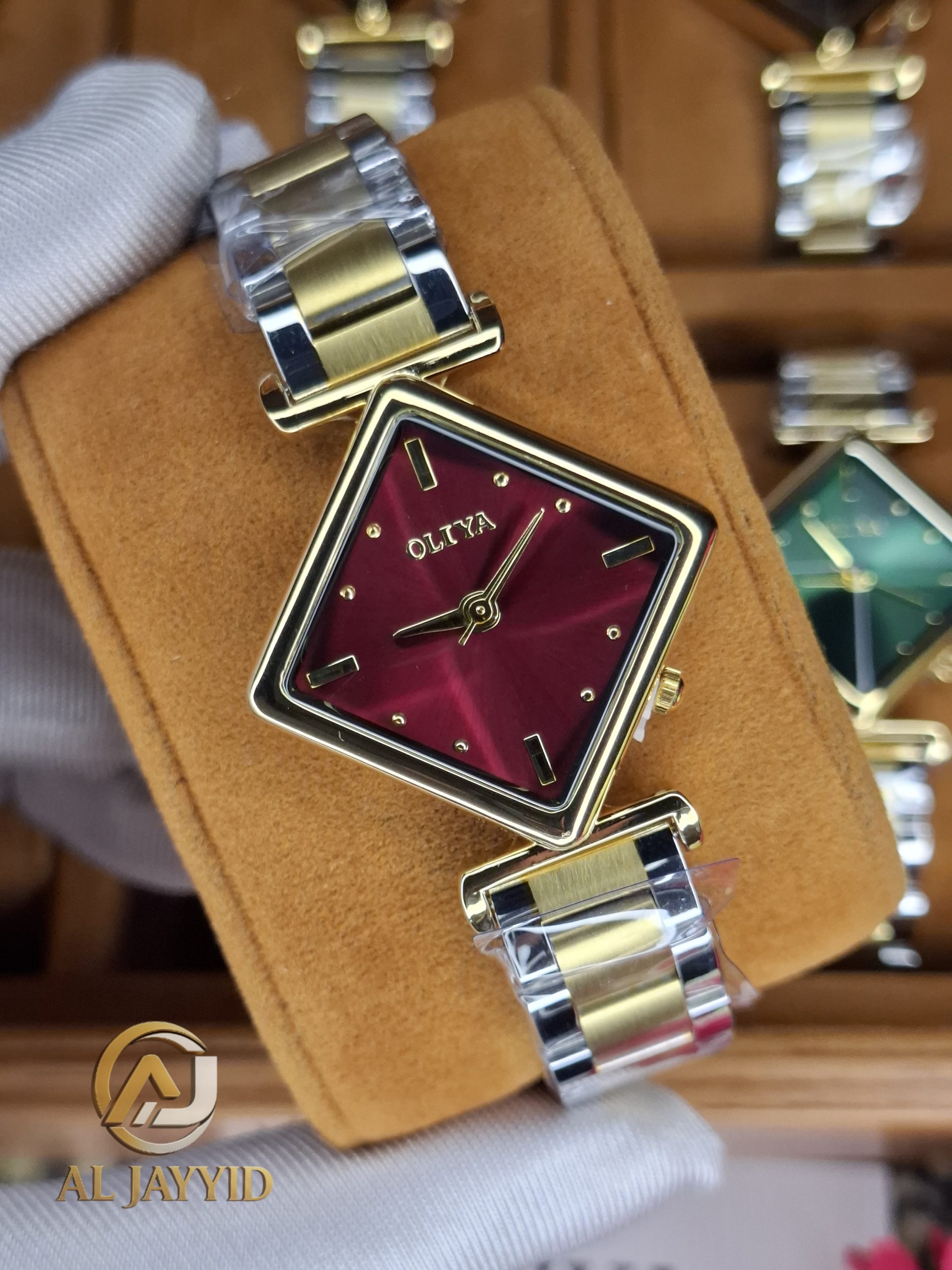 OLIYA 6819 women's watch with a square red dial, gold-tone case, and a two-tone gold and silver metal link bracelet.