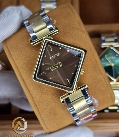 A gloved hand holding the OLIYA 6819 Women's Two-Tone Watch, showing its square brown dial and gold and silver bracelet.