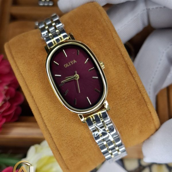 A close-up view of the OLIYA 2015 women's watch, showing its oval golden case, burgundy dial, and two-tone bracelet.