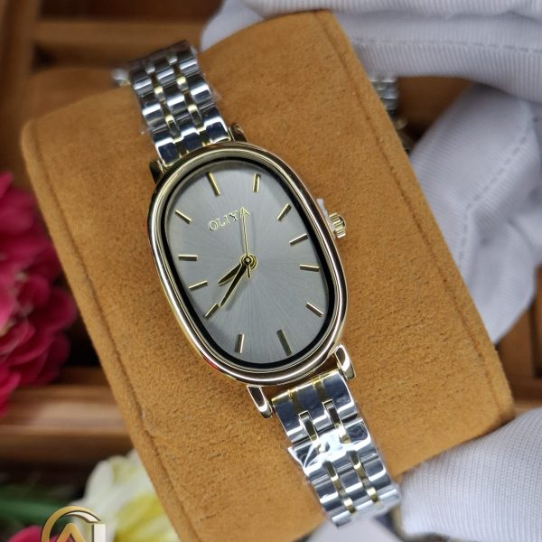 A close-up of the OLIYA 2015 women's watch, showing its gray oval dial with gold details and two-tone metal strap.
