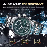 A POEDAGAR 960 luxury military watch with a green dial and steel bracelet, shown in a wet setting to highlight its waterproof feature.