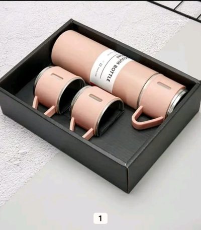 A pink vacuum flask set, including a bottle and two matching cups with handles, displayed in a black presentation box.