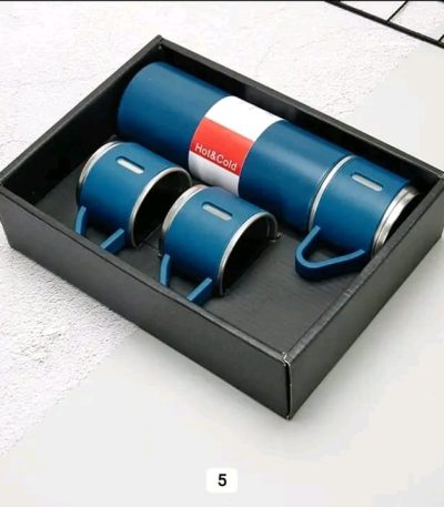 Blue vacuum flask with a 'Hot&Cold' label and two matching blue cups, neatly arranged in a black presentation box.