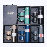 An assortment of colorful Vacuum Flask Set gift boxes displayed together, each containing a thermos and matching handled mugs.