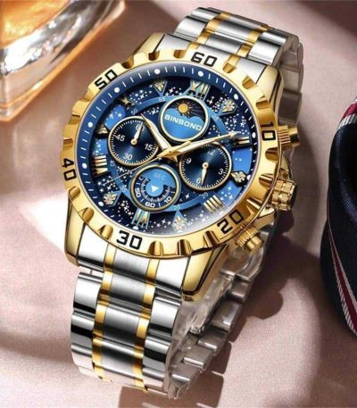 A close-up view of the BINBOND 7741 watch, featuring a blue starry dial, three subdials, and a two-tone gold and silver band.