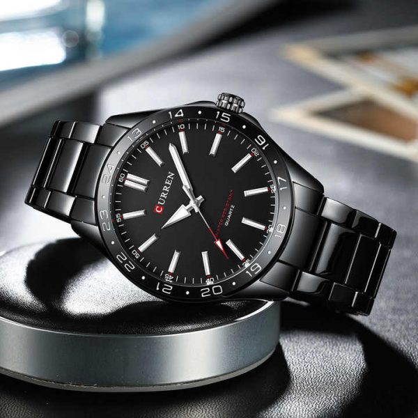 A black Curren 8452 quartz watch with a matching black metal link bracelet, angled on a display stand.