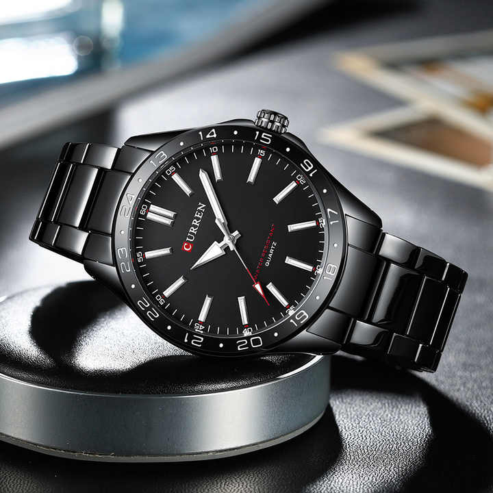 A black Curren 8452 quartz watch with a matching black metal link bracelet, angled on a display stand.