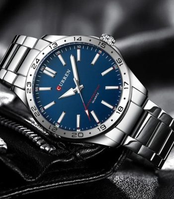 A silver-tone Curren 8452 quartz watch for men, featuring a striking blue dial and a metal link bracelet.