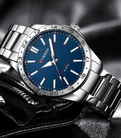 A silver-tone Curren 8452 quartz watch for men, featuring a striking blue dial and a metal link bracelet.
