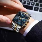 A man wearing the POEDAGAR 866 luxury square business wristwatch with a blue dial and a two-tone silver and gold metal strap.