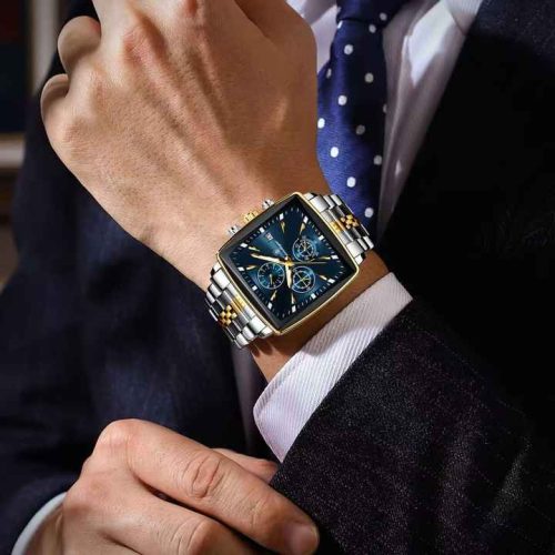 A man in a business suit adjusts his cuff, showing the POEDAGAR 866 luxury square wristwatch with a blue dial and two-tone bracelet.