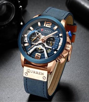 A close-up view of the CURREN 8329 Sport Watch for men, featuring a blue dial with rose gold details and a blue leather strap.