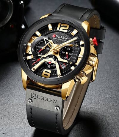 A close-up view of the CURREN 8329 sport watch, highlighting its black and gold chronograph dial and black leather strap.