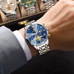 A man wearing the Poedagar 938 Men's Luxury Stainless Steel Chronograph watch with a striking blue dial and two-tone band.