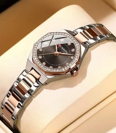 A CURREN 9100 women's luxury quartz watch featuring a two-tone rose gold and silver bracelet and a dark dial with crystals.
