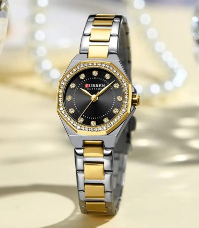 A CURREN 9100 ladies watch with a two-tone silver and gold band, black face, and a crystal-studded octagonal bezel.