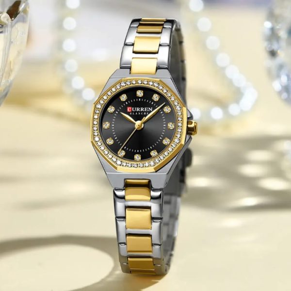 A CURREN 9100 ladies watch with a two-tone silver and gold band, black face, and a crystal-studded octagonal bezel.
