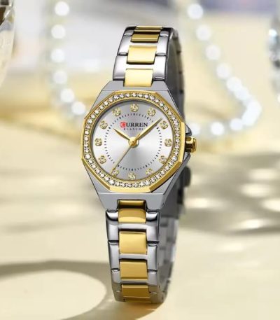 A Curren 9100 Lady watch with a two-tone silver and gold metal band, a white face, and a crystal-studded gold bezel.