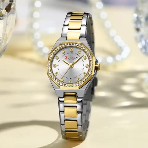 A Curren 9100 Lady watch with a two-tone silver and gold metal band, a white face, and a crystal-studded gold bezel.