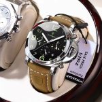 A POEDAGAR 859 luxury sports watch for men, featuring a silver case, a black dial with luminous numerals, and a brown strap.