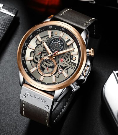 A close-up of the CURREN 8380 chronograph men's watch, featuring a gray and silver dial with a dark brown leather strap.