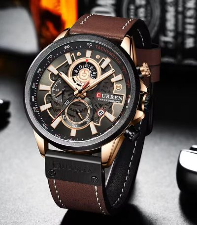A close-up view of the CURREN 8380 chronograph men's watch, showing its brown leather strap and rose gold case.