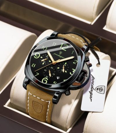 POEDAGAR 859 luxury sports mens watch with a black dial, gold hands, and a brown strap resting in a display box.