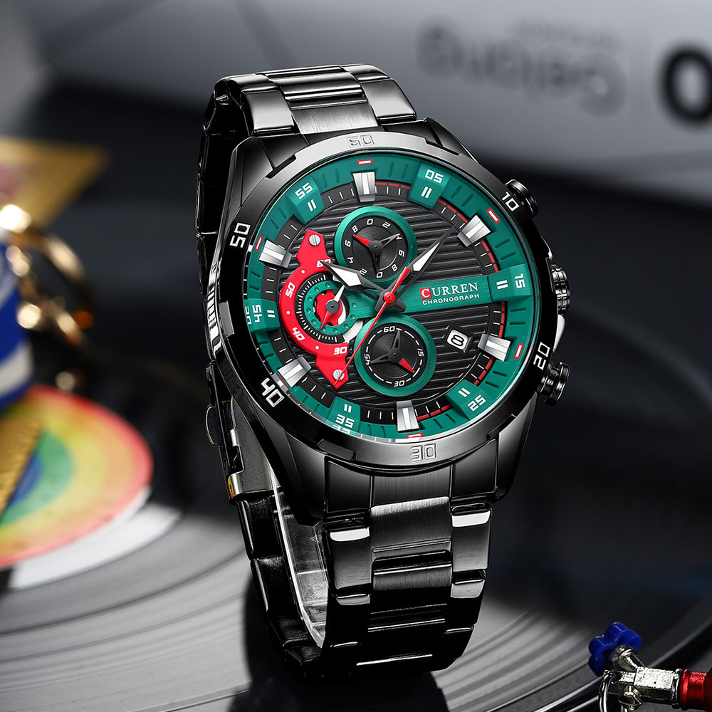 A close-up of the Curren 8402 watch in black, featuring its distinctive green and red detailed chronograph dial.