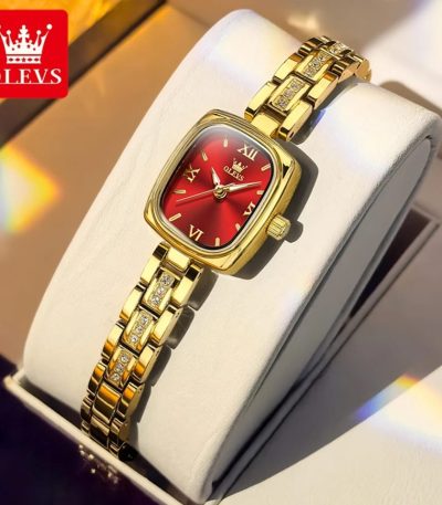 A close-up of the OLEVS 3695 women's quartz watch, showing its gold-colored case, red dial, and crystal-accented bracelet.
