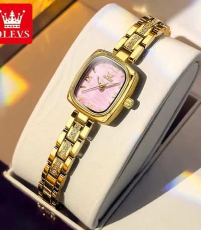 An OLEVS 3695 quartz women's watch with a gold-tone case and a pink dial, featuring a stone-accented link bracelet.
