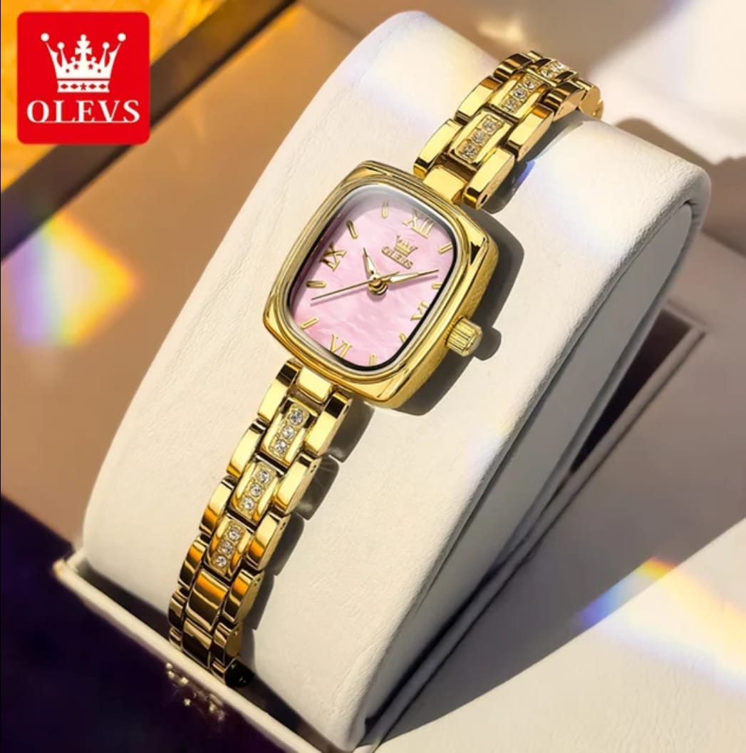 An OLEVS 3695 quartz women's watch with a gold-tone case and a pink dial, featuring a stone-accented link bracelet.